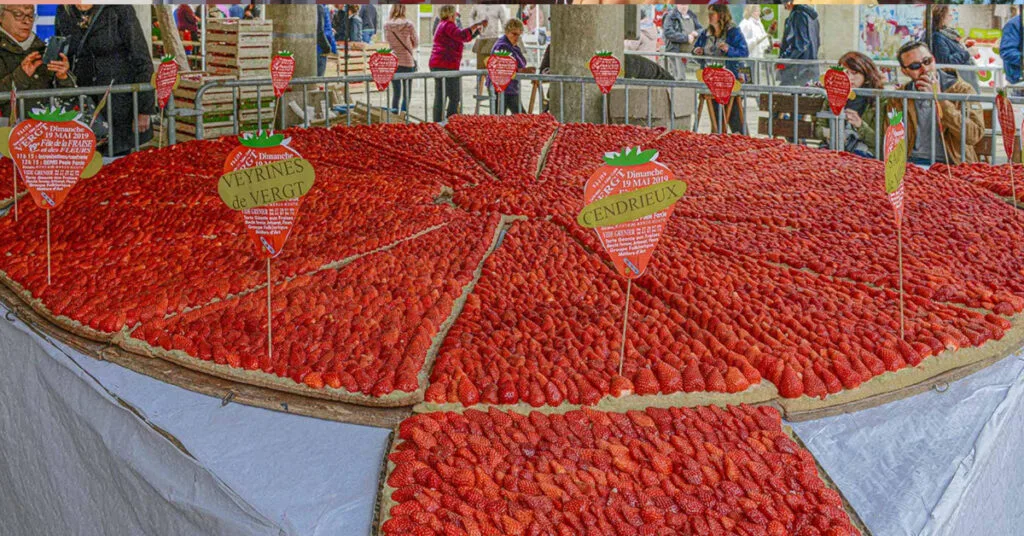 Variety of strawberries on display at the Fête de la Fraise in France.
